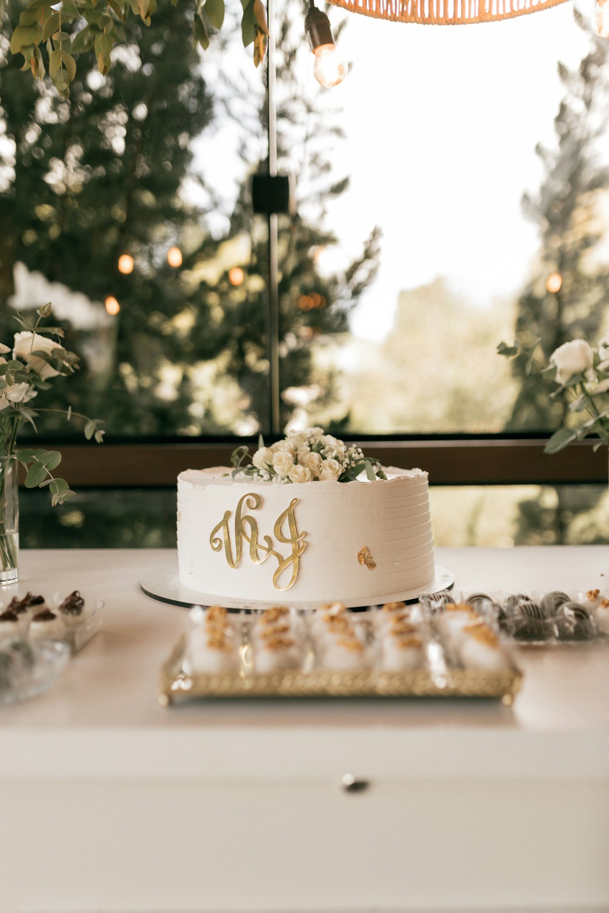 Intimate wedding reception table with gold accents and elegant floral centerpieces